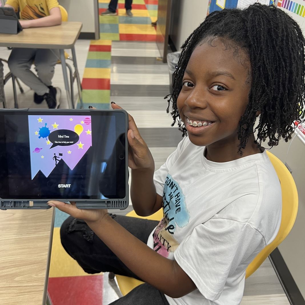  A student shows off her app on an iPad